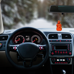 Divine Sansar-Saffron Hanumanji Statue-Car interior with dashboard lights on and a Saffron Hanumanji Statue on the dashboard.