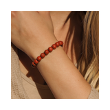 Divine Sansar-Stability Bracelet-Red Jasper bracelet on a person's wrist with a neutral background