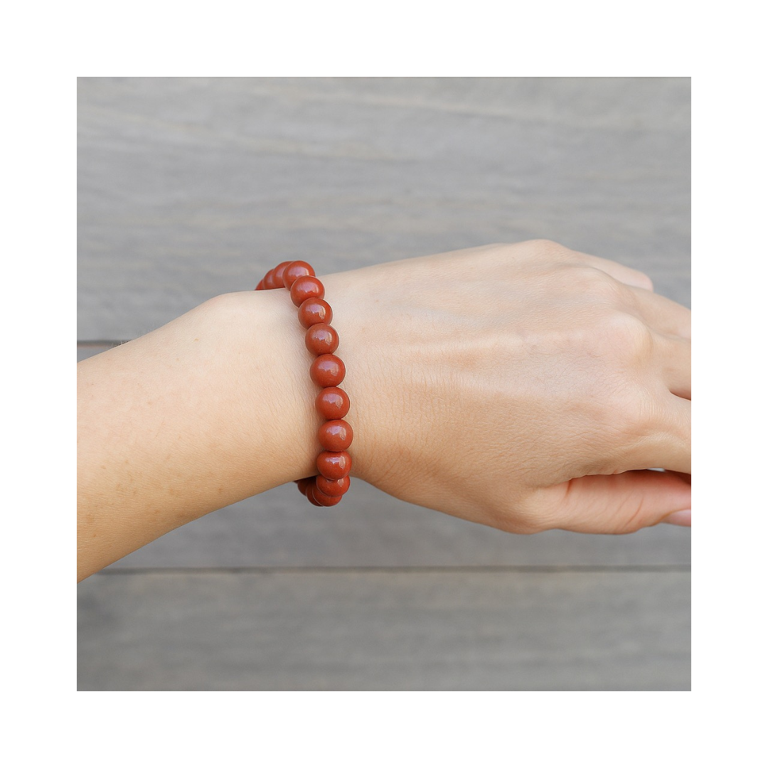 Divine Sansar-Stability Bracelet-Red Jasper bracelet on a wrist against a neutral background