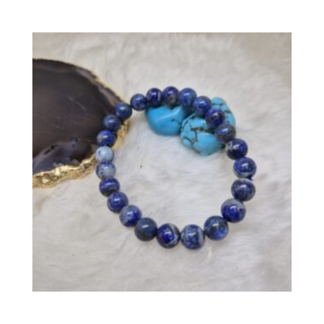Divine Sansar-WisdomBracelet-LapisLazuli bracelet with turquoise stones on a textured surface