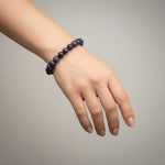 Divine Sansar-Wisdom Bracelet- Lapis Lazuli 7-an woman hand weaing a purple coloured wisdom bracelet lapis lazuli