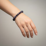 Divine Sansar-Wisdom Bracelet- Lapis Lazuli 7-an woman hand weaing a purple coloured wisdom bracelet lapis lazuli