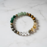 Divine Sansar-dhanyog bracelet natural crystal wealth prosperity uae-Multicolored beaded bracelet on a marble surface