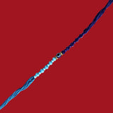 Divine Sansar Evil Eye Rakhi 1 with blue, white, and gold beads on a red background