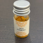 Divine Sansar Haldi Powder (Turmeric) bottle on a dark surface
