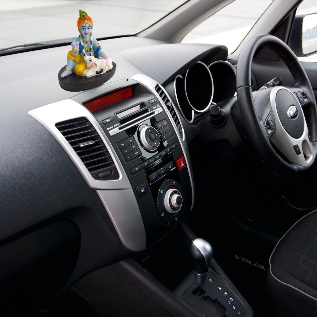Divine Sansar-Hand-Painted Baby Krishna with Calf Idol-Car dashboard with a Krishna with calf statue on the dashboard