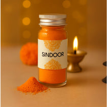 Divine Sansar Bottle of Sindoor with a decorative label on a warm-toned background