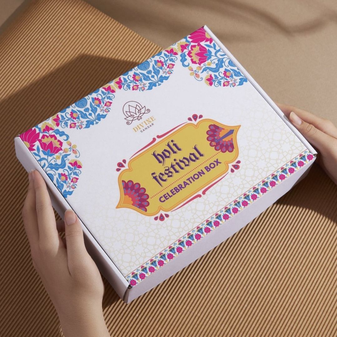 Divine Sansar-A rectangular white and yellow gift box labeled "Holi Festival Celebration Box"