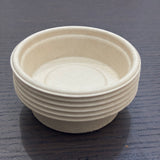 Divine Sansar-a small stack of eco-friendly, biodegradable paper or sugarcane bagasse cups.