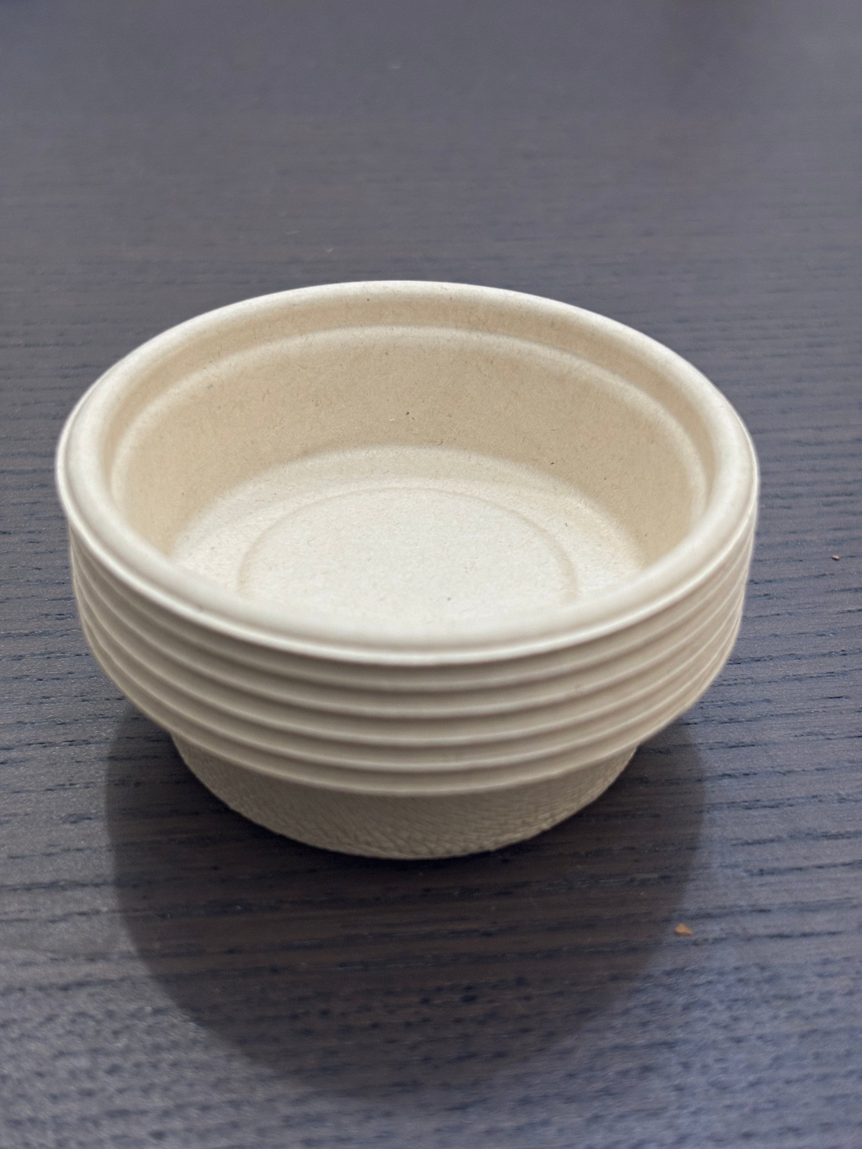 Divine Sansar-a small stack of eco-friendly, biodegradable paper or sugarcane bagasse cups.