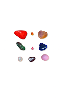 Divine Sansar Collection of various colored gemstones on a white background