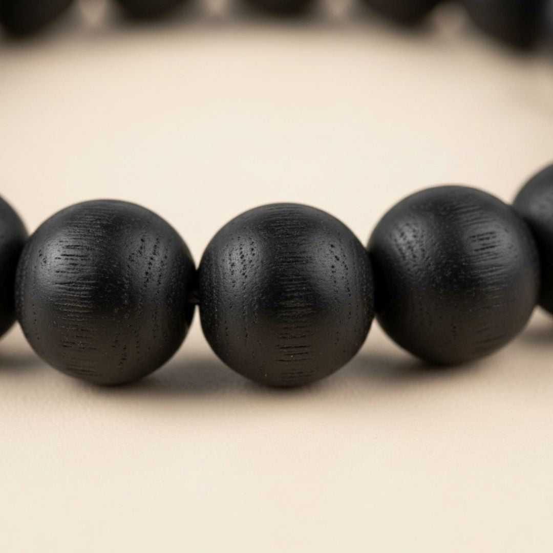 Close-up of Karungali black ebony 8mm beads showing natural wood grain - Divine Sansar