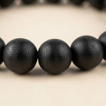Close-up of Karungali black ebony 8mm beads showing natural wood grain - Divine Sansar