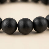 Close-up of Karungali black ebony 8mm beads showing natural wood grain - Divine Sansar