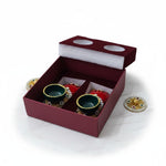Laxmi Charan gift box open with the lid alongside, its foam pad die-cut with two round seats for the covers, and the terracotta pair seated in the maroon box, Divine Sansar