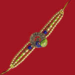 Divine Sansar Meenakari Peacock Rakhi Design 1, made with gold beads and colorful stone on a red background