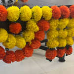Divine Sansar-Premium Artificial Marigold Toran: Lemon & Orange Flower Strings-hanging in decorative swags. 