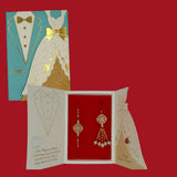 Divine Sansar-Premium Bhaiya Bhabhi Rakhi Design 1 with a decorated card on a red background