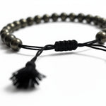 Close-up of the braided pyrite bracelet sliding knot and black tassel - Divine Sansar