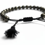 Close-up of the braided pyrite bracelet sliding knot and black tassel - Divine Sansar
