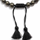 Macro of the black macrame sliding knot and twin tassels on the Braided Fit pyrite bracelet - Divine Sansar