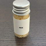 Divine Sansar Rice bottle with a metal lid on a dark surface