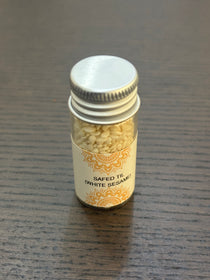 Divine Sansar Safed Til-Small jar of white sesame seeds with a decorative label on a wooden surface