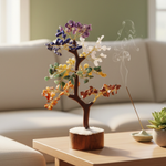 Seven Chakra Crystal Tree of Life self-chargingon a table with a insence and blurred background