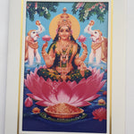 Divine Sansar Vaibhav Laxmi Photo Frame on a pink lotus with two elephants and flowers in the background.