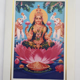 Divine Sansar Vaibhav Laxmi Photo Frame on a pink lotus with two elephants and flowers in the background.