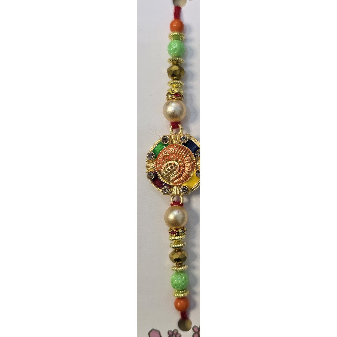 Gold Om meenakari rakhi close up Divine Sansar