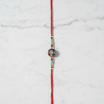Aumkara Om Meenakari Rakhi on marble - Divine Sansar UAE