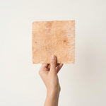 Bhoj patra sheet held in hand to show size - Divine Sansar