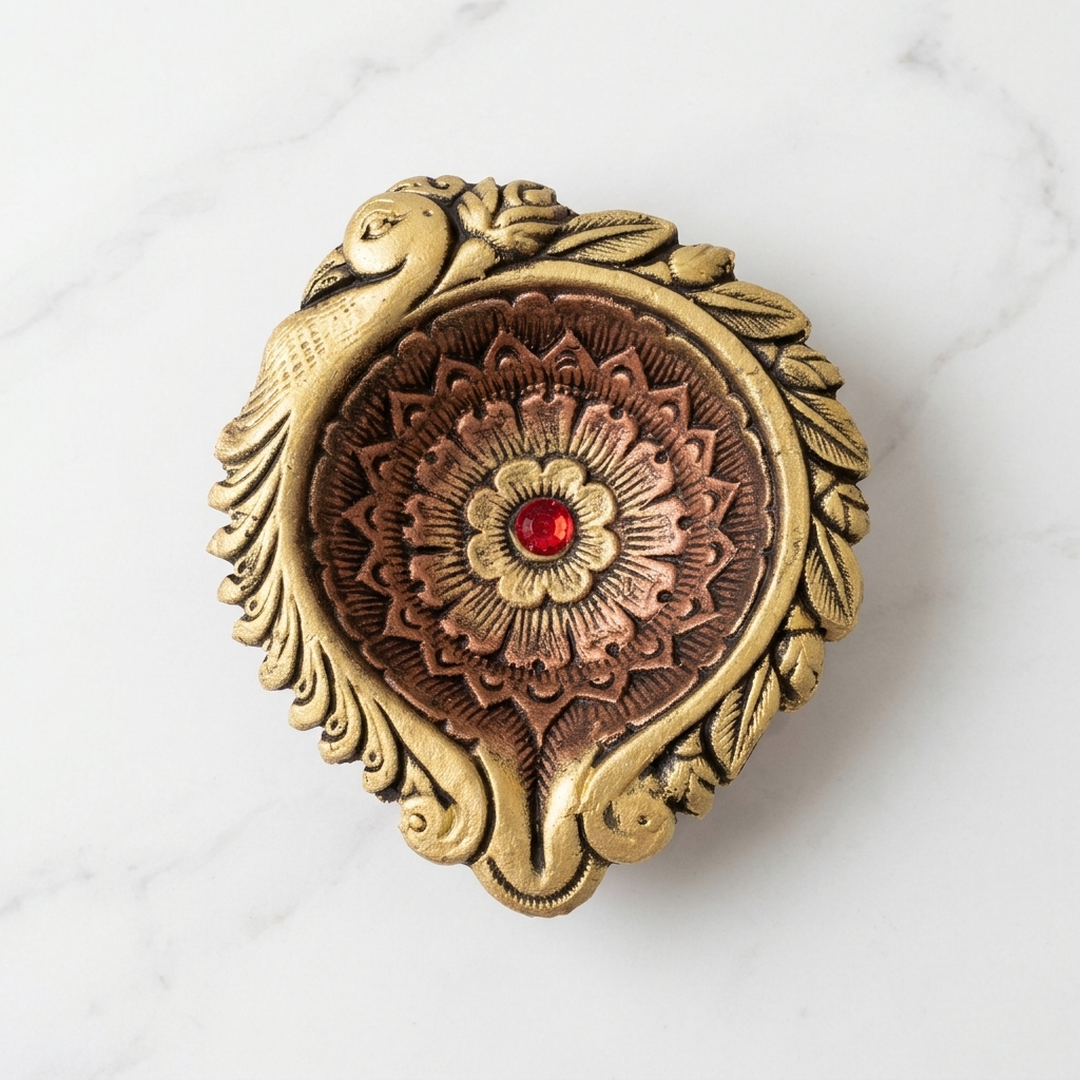 Top view of the big peacock clay diya showing the carved lotus mandala bowl and red stone - Divine Sansar