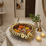 Big clay diya used as an urli with water and floating marigold petals in a Dubai home entrance - Divine Sansar
