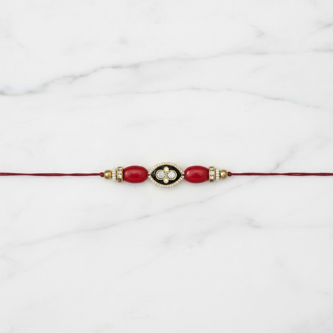 Coral meenakari moonga rakhi on marble - Divine Sansar