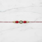 Coral meenakari moonga rakhi on marble - Divine Sansar