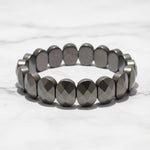 Flat faceted pyrite bead bracelet on white marble - Divine Sansar UAE