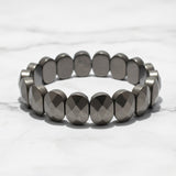 Flat faceted pyrite bead bracelet on white marble - Divine Sansar UAE