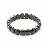Top view of flat pyrite stretch bracelet money magnet - Divine Sansar