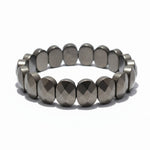 Flat pyrite bracelet with 20 faceted oval beads on white background - Divine Sansar