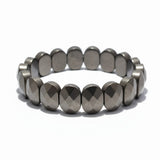 Flat pyrite bracelet with 20 faceted oval beads on white background - Divine Sansar
