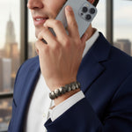 Man wearing flat pyrite bead bracelet on left wrist in a Dubai office - Divine Sansar
