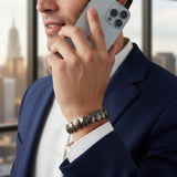 Man wearing flat pyrite bead bracelet on left wrist in a Dubai office - Divine Sansar