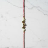 Gaja Sri Gold Elephant Rakhi on marble - Divine Sansar UAE