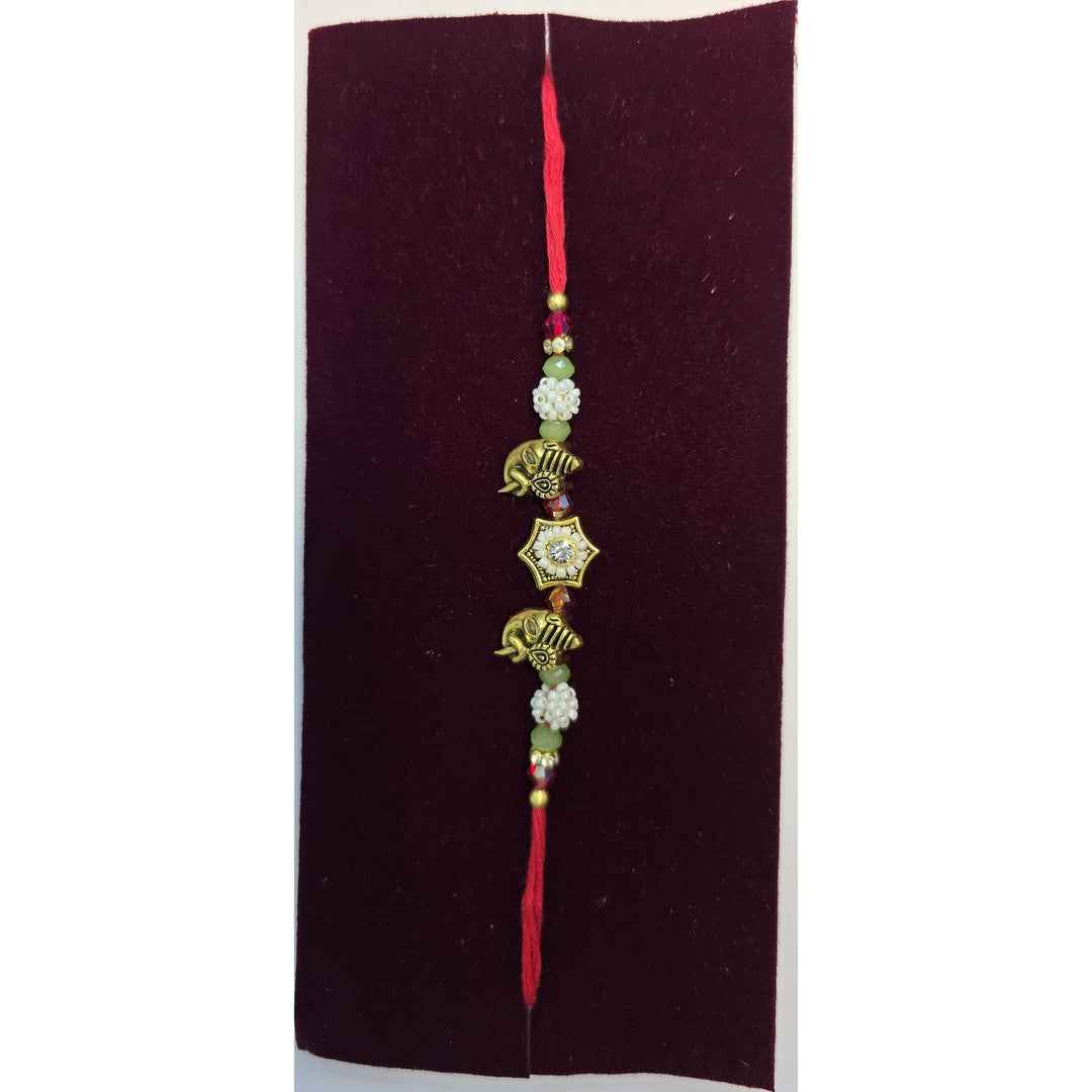 Gold elephant motif rakhi close up Divine Sansar