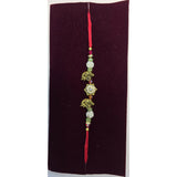 Gold elephant motif rakhi close up Divine Sansar
