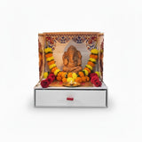 Handmade clay Ganesh idol seated inside the Mangal Bhawan portable temple with marigold garland, Divine Sansar