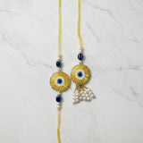 Golden evil eye nazar rakhi lumba set on marble - Divine Sansar