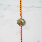 Golden lotus gota rakhi on marble - Divine Sansar